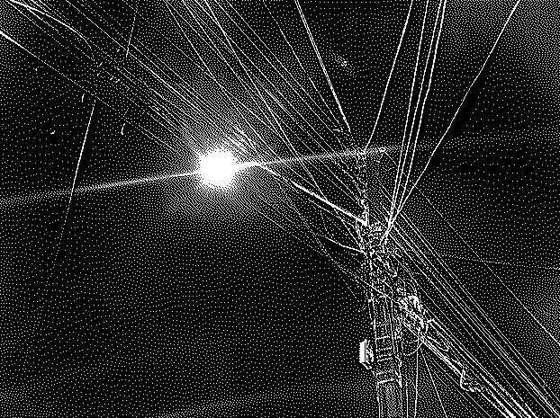 An image of an utility pole at night.